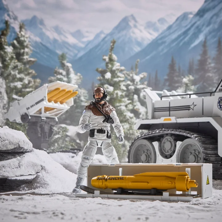 The Frostbite figure standing beside an opened side cargo crate marked AVALANCHE holding a yellow ski missile, with the Snow C.A.T. tracks and turret behind him